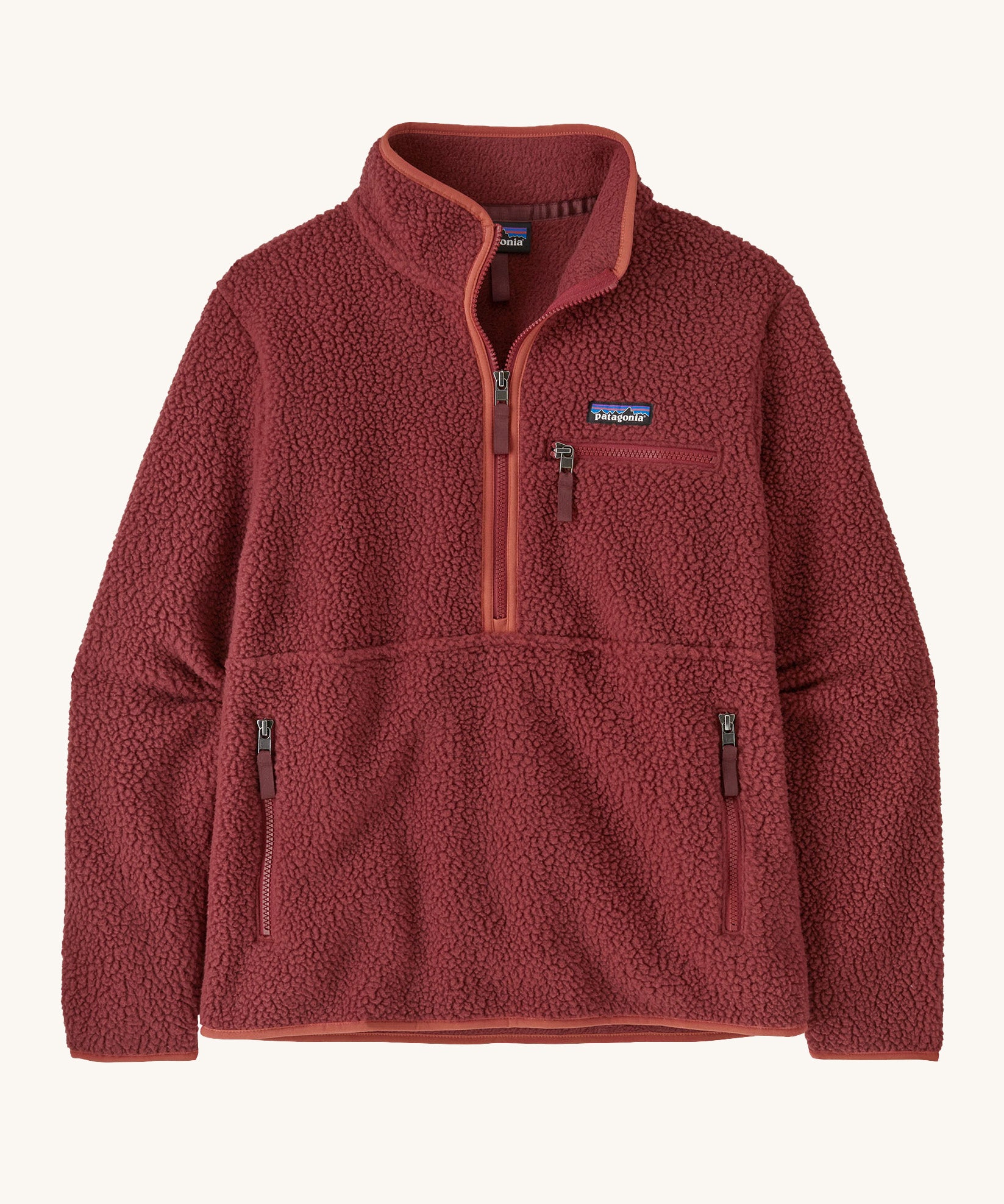 Patagonia women's marsupial retro pile fleece in sequoia red. A thick fleece in a rich red colour with light red trim. Features  2 side and chest pockets with a brand patch stitched on the chest and a half length zip.