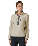 A woman wearing the Patagonia natural marsupial retro fleece showing front trim and zip detail available at Babipur.