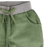 A close up of the Pigeon Organics lined cord trousers available at Babipur showing the grey elasticated waistband and green drawstring detail