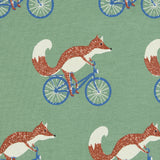 Close up of the Pigeon Organics cycling fox printed on organic green cotton fabric.