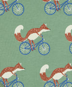 Close up of the Pigeon Organics cycling fox printed on organic green cotton fabric.