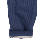 A close up of the Pigeon Organics lined cord trousers available at Babipur showing the ankle cuff turned up revealing the striped inner lining