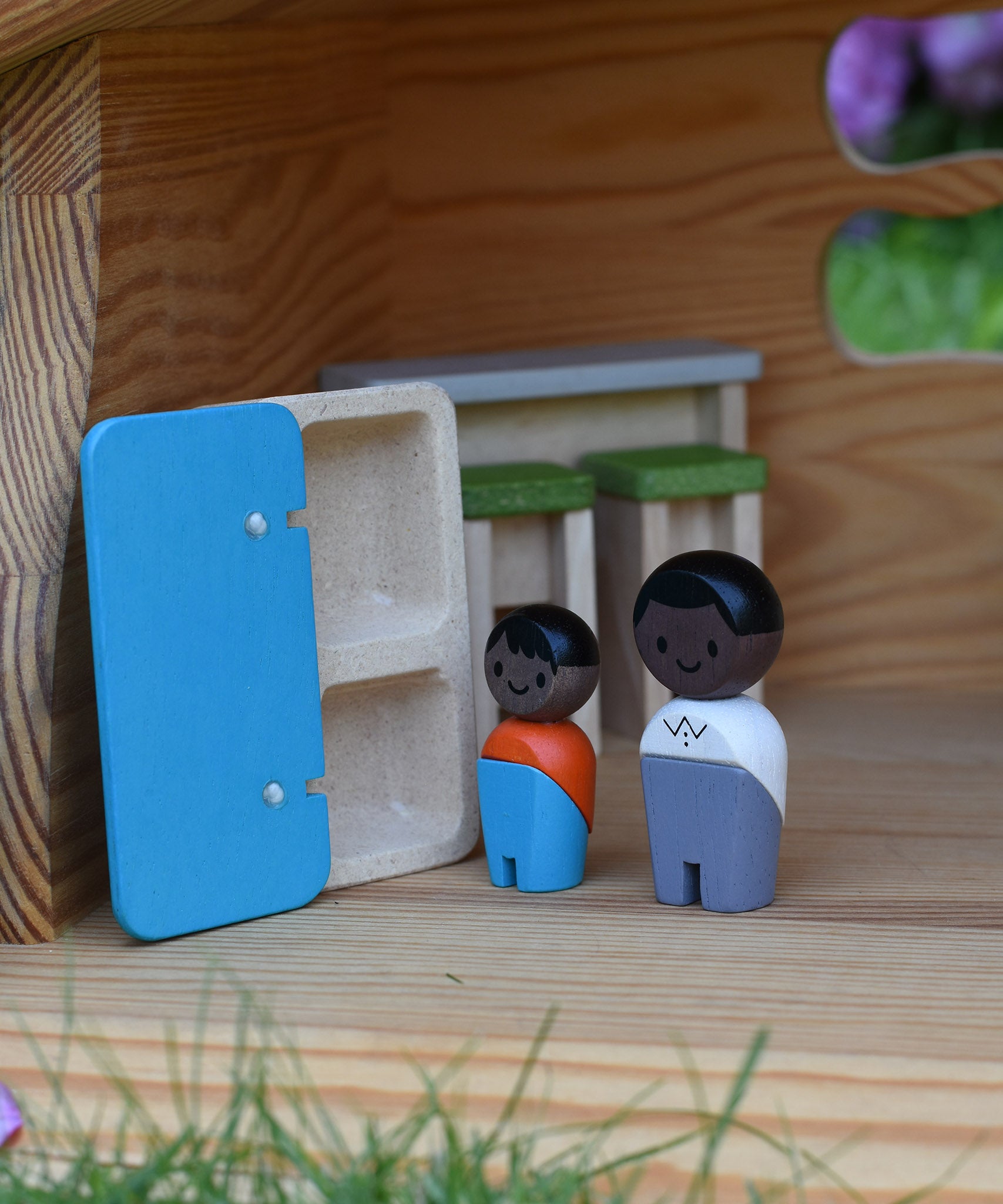 The Plan Toys black skin, black hair wooden doll family placed in an Ostheimer dolls house with wooden PlanToys dolls house furniture.
These wooden toys are part of a large range of wooden toys here at Babipur.