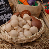 Wooden toy mushrooms from the Plan Toys Produce Set - a set of vegetable play food - in a rattan basket.