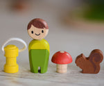 A line up of the lamp, doll, toadstool and squirrel pieces that come with the PlanToys PlanWorld tree house set.