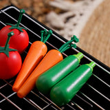 Plan Toys Vegetable Produce Set - Carrots, Courgettes & Tomatoes. The wooden play food is shown on a grill.