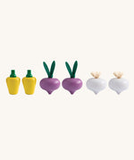 Plan Toys wooden play food Produce Set containing Radish, Garlic & Yellow Peppers. The produce have been lined up.