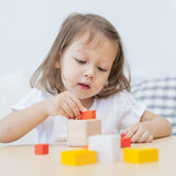 A child playing with the PlanToys Fractions Cubes.