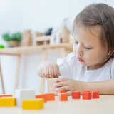 A child playing with the PlanToys Fractions Cubes.