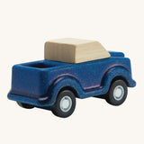 A view of the back of a PlanToys Blue Truck on a plain background.