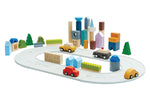 PlanToys eco-friendly wooden city blocks and rubber road set on a white background in a small town scene