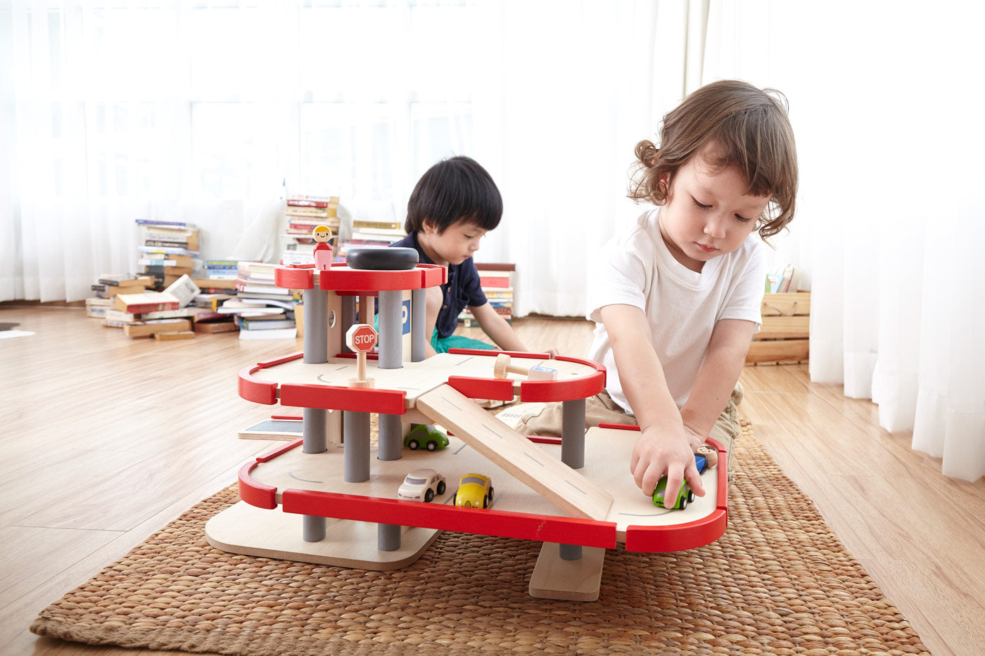 Children playing with the PlanToys PlanWorld Parking Garage.