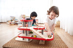 Children playing with the PlanToys PlanWorld Parking Garage.