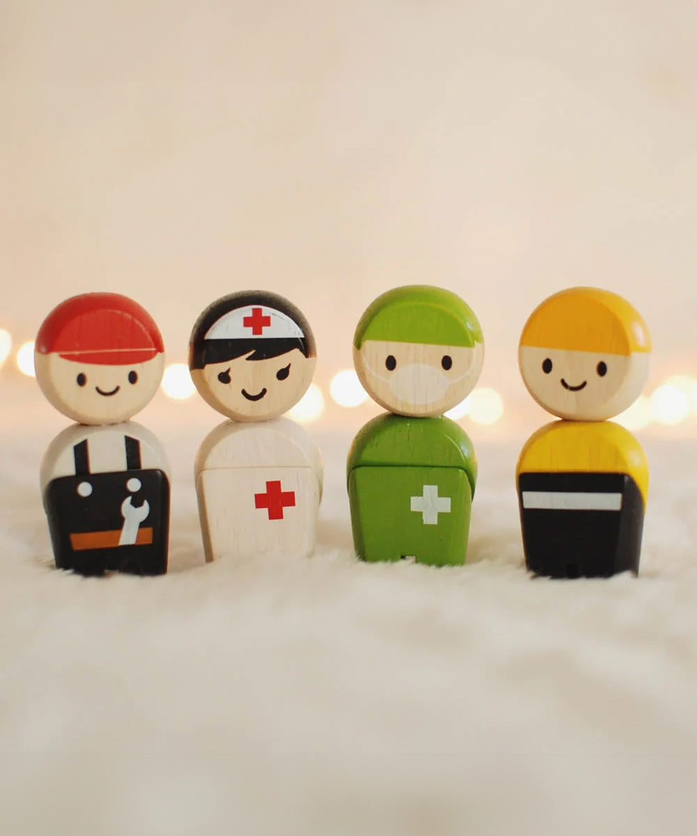 The PlanToys PlanWorld Rescue Crew on a fluffy surface, fairy lights can be seen in the background.