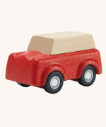 PlanToys Red SUV toy car on a plain background.