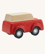 A view of teh back of a PlanToys Red SUV toy car on a plain background.