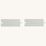 Two pieces from the PlanToys Rubber Road and Rail Straights Extension Set on a plain background.