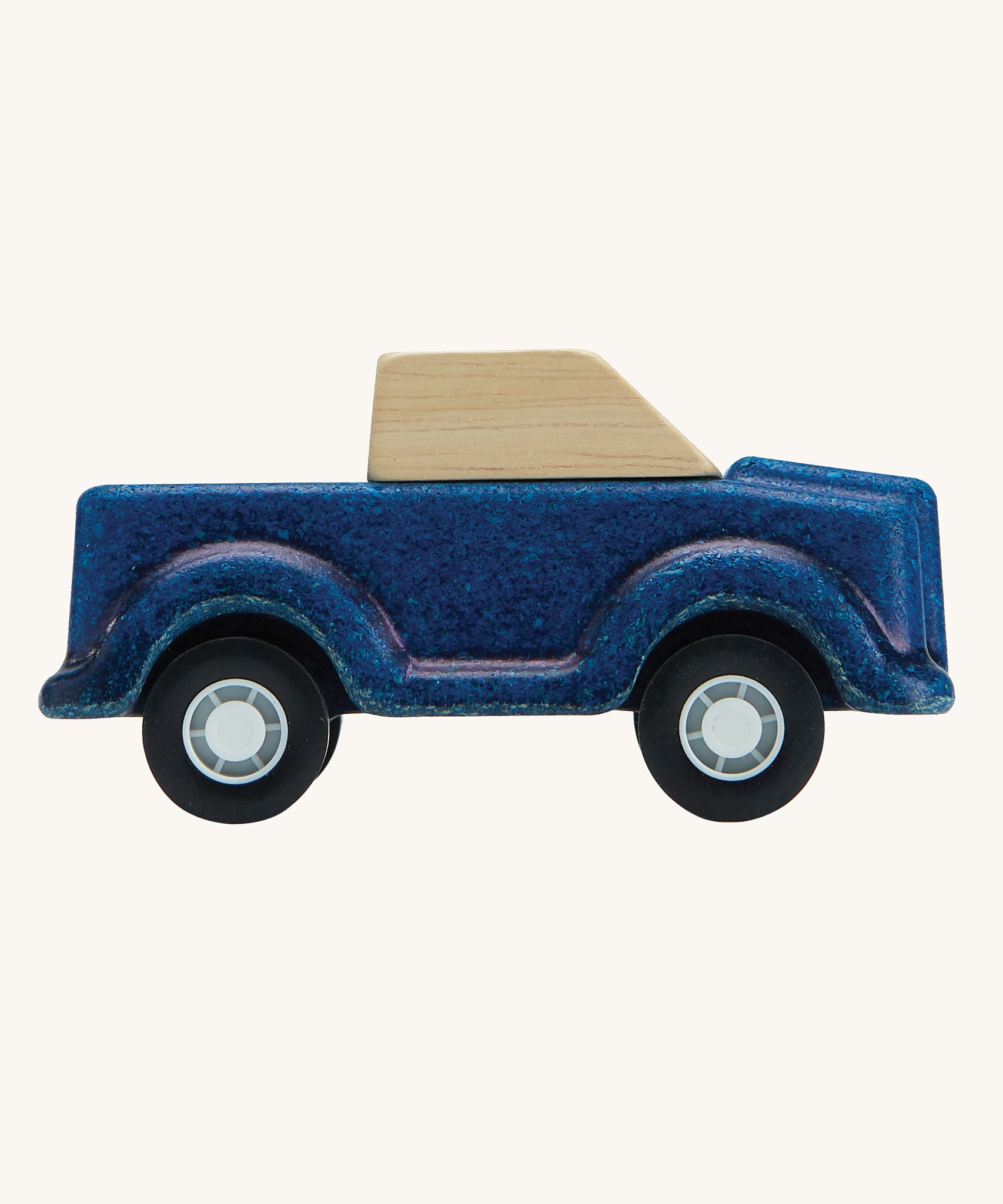 A side on view of the PlanToys Blue Truck on a plain background.