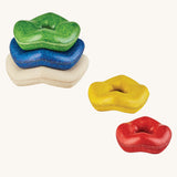 Plan Toys Wave Stacker wooden baby toy with rainbow rings.