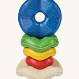 The Plan Toys Wave wooden Stacker shown with the smallest piece at the bottom.