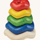 PlanToys Wave Stacker wooden baby toy with rainbow rings.