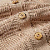 A close up of the wooden buttons on the Rapanui Brook Organic Cotton Women's Knitted Cardigan.