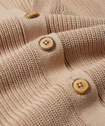 A close up of the wooden buttons on the Rapanui Brook Organic Cotton Women's Knitted Cardigan.