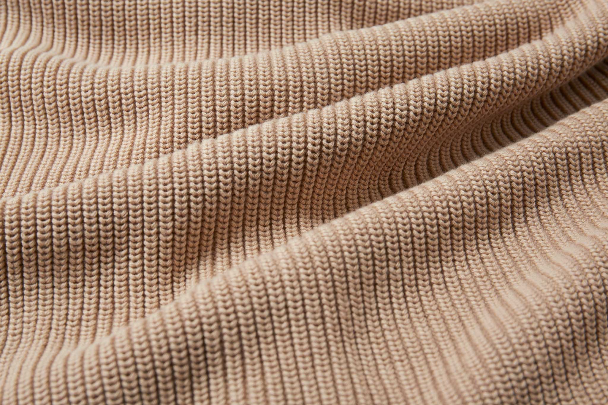 A close up of the material of the Rapanui Brook Organic Cotton Women's Knitted Cardigan. The material has been scrunched together.