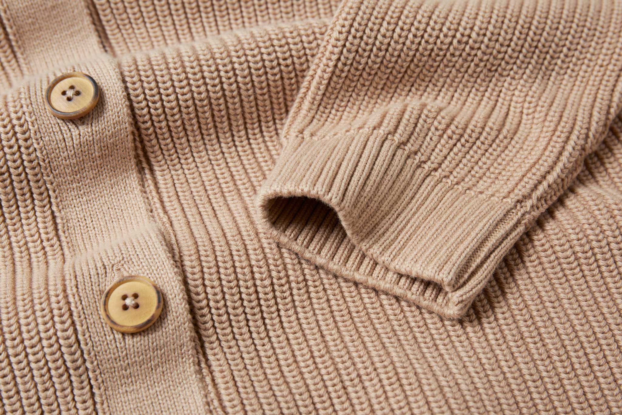 A close up of teh sleeve cuff on the Rapanui Brook Organic Cotton Women's Knitted Cardigan.