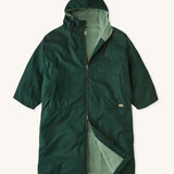 Rapanui changing robe in evergreen colour. A organic cotton long length changing robe with PFC-free water-resistant coating and a towelling lining. Features a two way zip and a hood with pouch pockets.