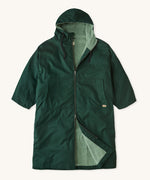 Rapanui changing robe in evergreen colour. A organic cotton long length changing robe with PFC-free water-resistant coating and a towelling lining. Features a two way zip and a hood with pouch pockets.