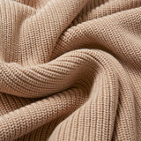 A close up of the material of the Rapanui Brook Organic Cotton Women's Knitted Cardigan. The material has been scrunched together.