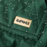 A close up of the brand patch stitched on the pocket of the Rapanui chanigng rope showing the effect of the PVC free water resisting coating on evergreen organic cotton fabric
