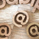 Numbers and Symbols laid out on a wooden floor spelling the word Babipur