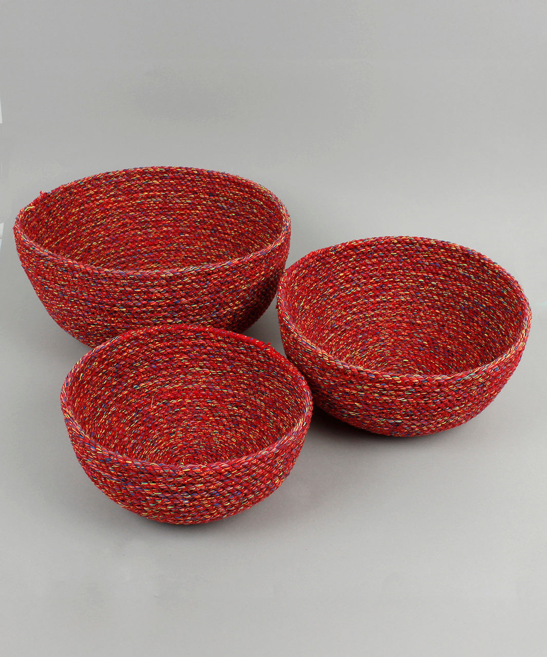 A close up of the 3 Respiin multicoloured recycled cotton bowls spread out showing the size difference