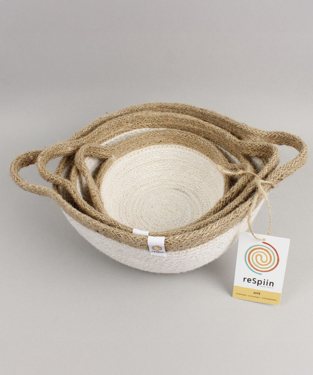 A close up of the Respiin white and natural jute handled bowls showing each bowl inside each other