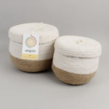 Respiin natural jute lidded basket set. A set of 2 white and natural baskets. Showing the matching white lids on on top and brand tag.