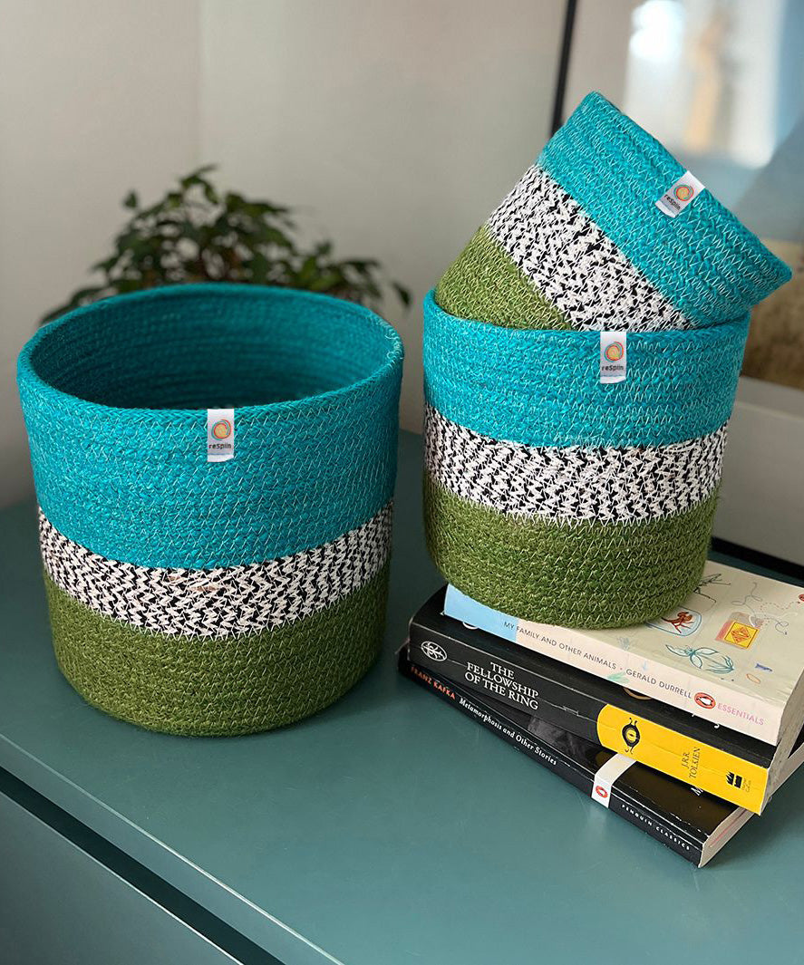 Respiin jute ocean zig zag basket set standing upright on a drawer in a bedroom with a smaller and middle basket standing on top of books