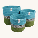 Respiin jute zig zag basket in ocean. 3 different sized basket that can fit inside each other. Each basket is light blue on the top, green on the bottom with a black and white pattern through the middle.