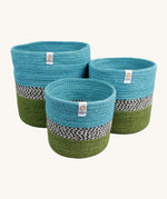Respiin jute zig zag basket in ocean. 3 different sized basket that can fit inside each other. Each basket is light blue on the top, green on the bottom with a black and white pattern through the middle.