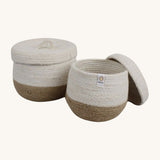 Respiin natural jute lidded basket set. A set of 2 white and natural baskets with matching white lids. Features a little handle on top for easy opening