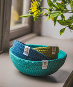 ReSpiin Jute Multicoloured Mini Bowl Set of 3 in the ocean colourway nestled inside each other placed on a window sill