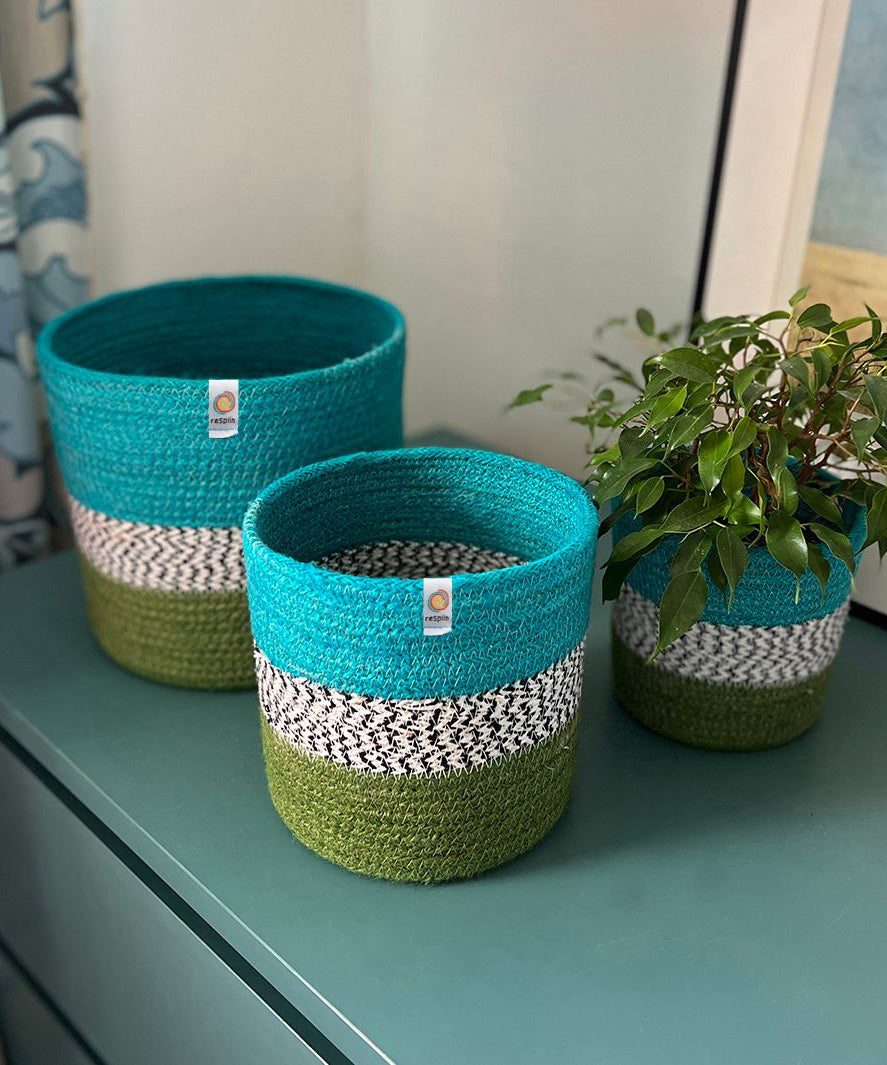 Respiin jute ocean zig zag basket set standing upright on a drawer in a bedroom with a plant in the smallest basket