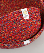 A close up of the 3 Respiin multicoloured recycled cotton bowls showing the weave detail and brand patch stitched on the rim