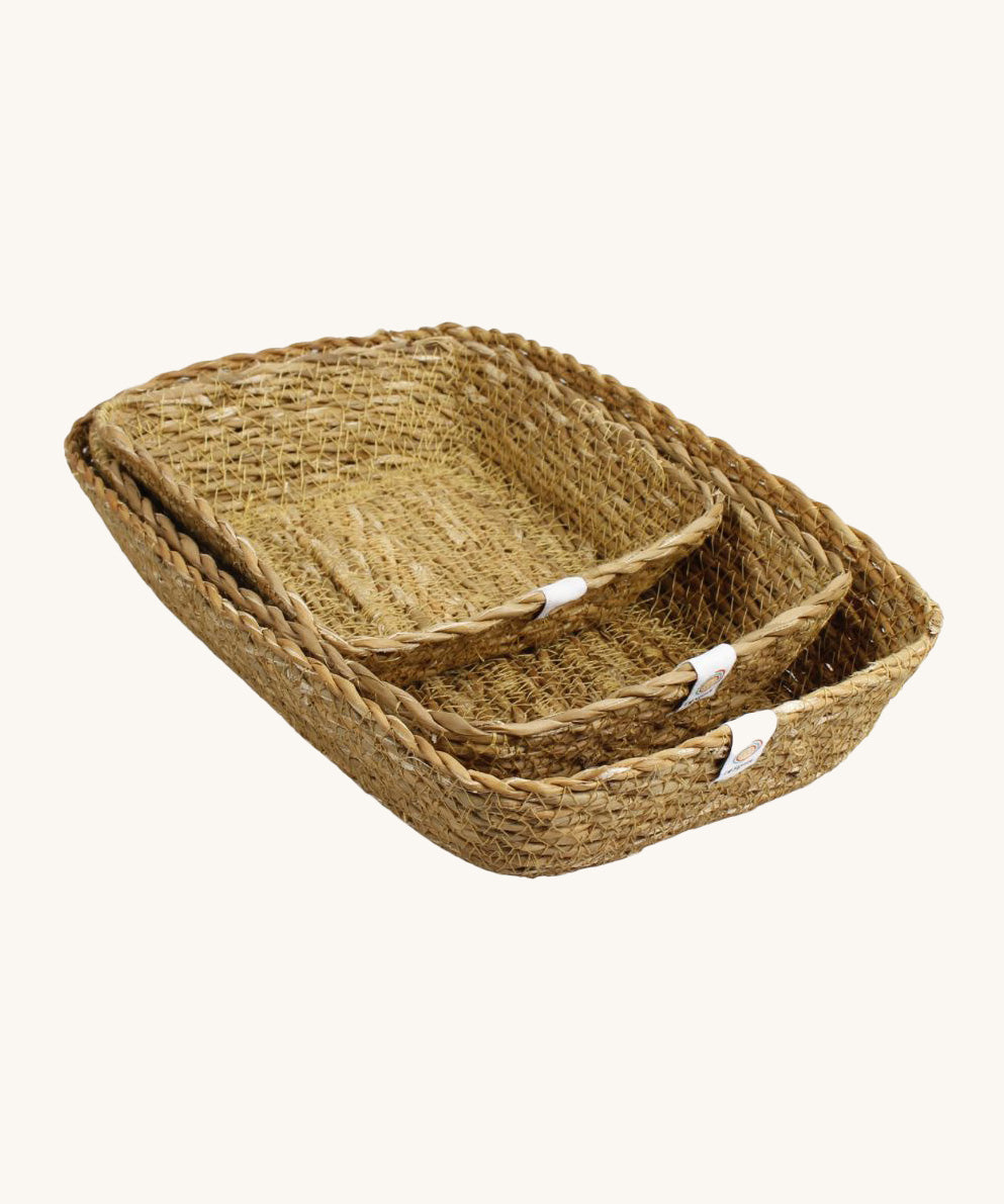 A set of 3 seagrass rectangular basket set in natural. Showing the different sized basket inside each other