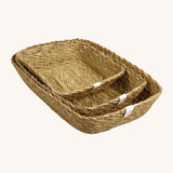 A set of 3 seagrass rectangular basket set in natural. Showing the different sized basket inside each other