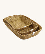 A set of 3 seagrass rectangular basket set in natural. Showing the different sized basket inside each other