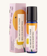 Roll On Sleep Well Essential Oil Blend in a blue glass bottle next to it's decorative pink cardboard box.