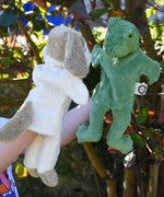 Senger dog and frog puppet toys in use on a child's hands.