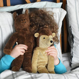 A child holding up a horse and hedgehog Senger floppy soft toys in front of their face whilst playing peekaboo with them. These toys are from the Senger Floppy collection, a range of soft toy animals made from organic and natural materials.